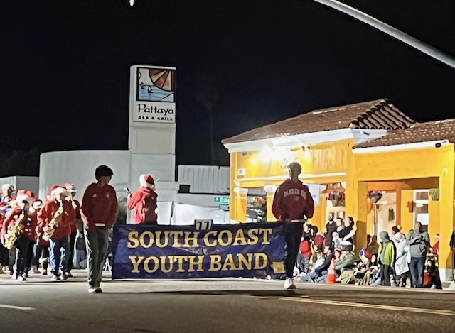 marching band carrying a banner
