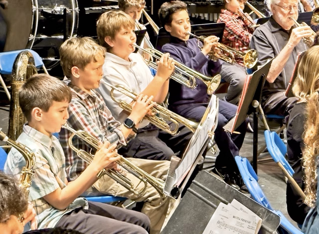 boys in the band playing their instruments